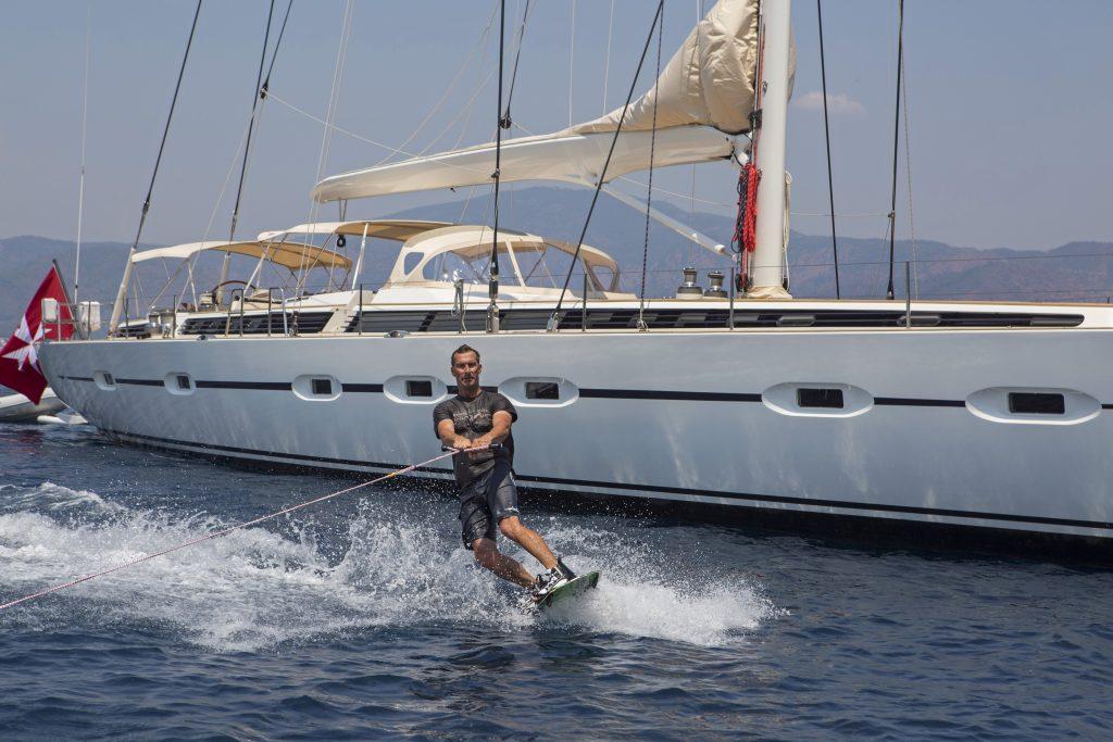 Sailing yacht with water-skier