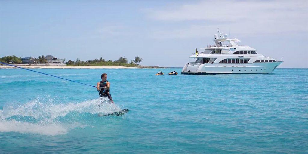 Family yacht vacation offers many activities on board. Shown are jet skis and kite surfing.