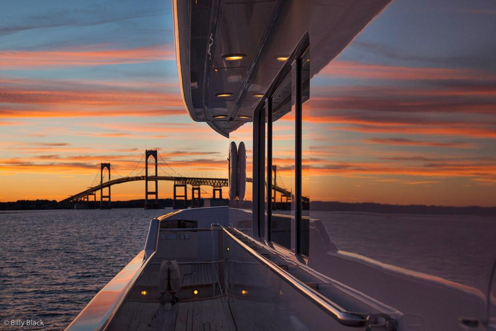 Aesthetic image of the Newport Bridge while aboard motor yacht at sunset