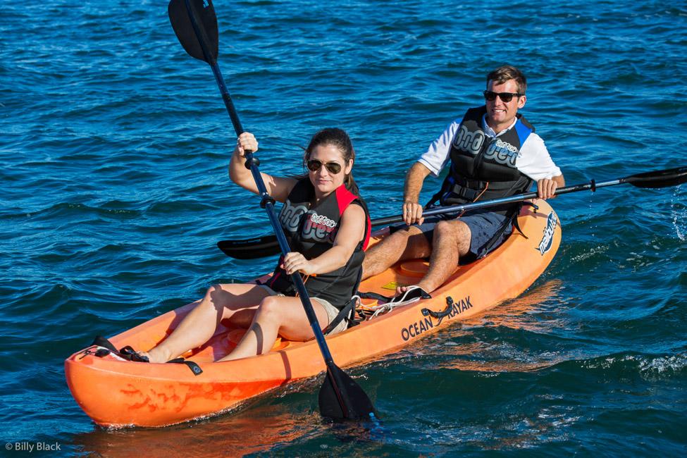 Guests kayaking while on their luxury charter vacation