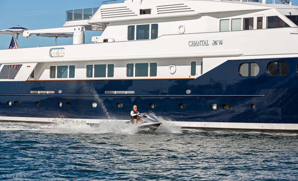 Guest enjoying jetski while chartering super yacht